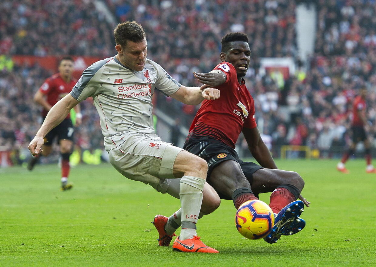 epa07393094 Liverpool's James Milner (L) in action with Manchester United's Paul Pogba during the English Premier League soccer match between Manchester United and Liverpool FC held at the Old Trafford in Manchester, Britain, 24 February 2019. EPA/PETER POWELL EDITORIAL USE ONLY.No use with unauthorized audio, video, data, fixture lists, club/league logos or 'live' services. Online in-match use limited to 120 images, no video emulation.No use in betting, games or single club/league/player publications