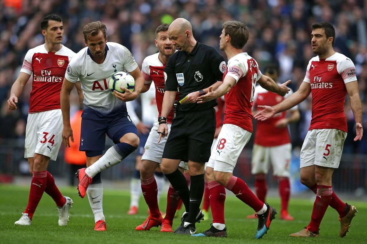 Referee Anthony Taylor (C) indicates a penalty to Tottenham during the English Premier League football match between Tottenham Hotspur and Arsenal at Wembley Stadium in London, on March 2, 2019. (Photo by Daniel LEAL-OLIVAS / AFP) / RESTRICTED TO EDITORIAL USE.No use with unauthorized audio, video, data, fixture lists, club/league logos or 'live' services. Online in-match use limited to 120 images. An additional 40 images may be used in extra time.No video emulation. Social media in-match use limited to 120 images. An additional 40 images may be used in extra time.No use in betting publications, games or single club/league/player publications. /