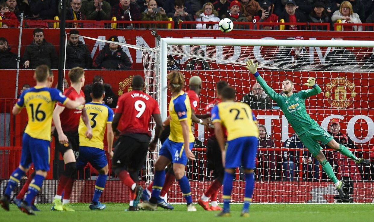 Southampton's English midfielder James Ward-Prowse (L) watches as his freekick beats Manchester United's Spanish goalkeeper David de Gea (R) making the score 2-2, during the English Premier League football match between Manchester United and Southampton at Old Trafford in Manchester, north west England, on March 2, 2019. (Photo by Oli SCARFF / AFP) / RESTRICTED TO EDITORIAL USE.No use with unauthorized audio, video, data, fixture lists, club/league logos or 'live' services. Online in-match use limited to 120 images. An additional 40 images may be used in extra time.No video emulation. Social media in-match use limited to 120 images. An additional 40 images may be used in extra time.No use in betting publications, games or single club/league/player publications. /