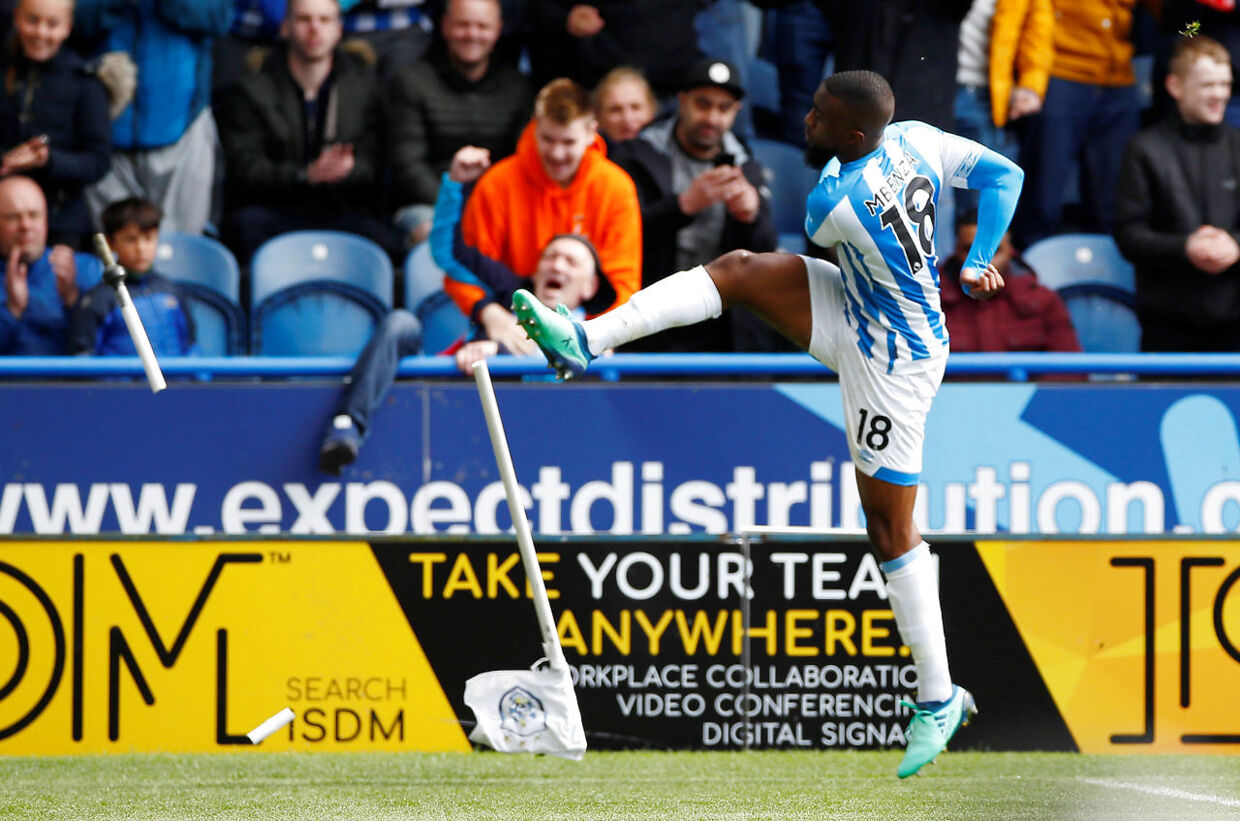 Soccer Football - Premier League - Huddersfield Town v Manchester United - John Smith's Stadium, Huddersfield, Britain - May 5, 2019 Huddersfield Town's Isaac Mbenza celebrates scoring their first goal and kicks the corner flag Action Images via Rceuters/Jason Cairnduff EDITORIAL USE ONLY.No use with unauthorized audio, video, data, fixture lists, club/league logos or "live" services. Online in-match use limited to 75 images, no video emulation.No use in betting, games or single club/league/player publications. Please contact your account representative for further details.