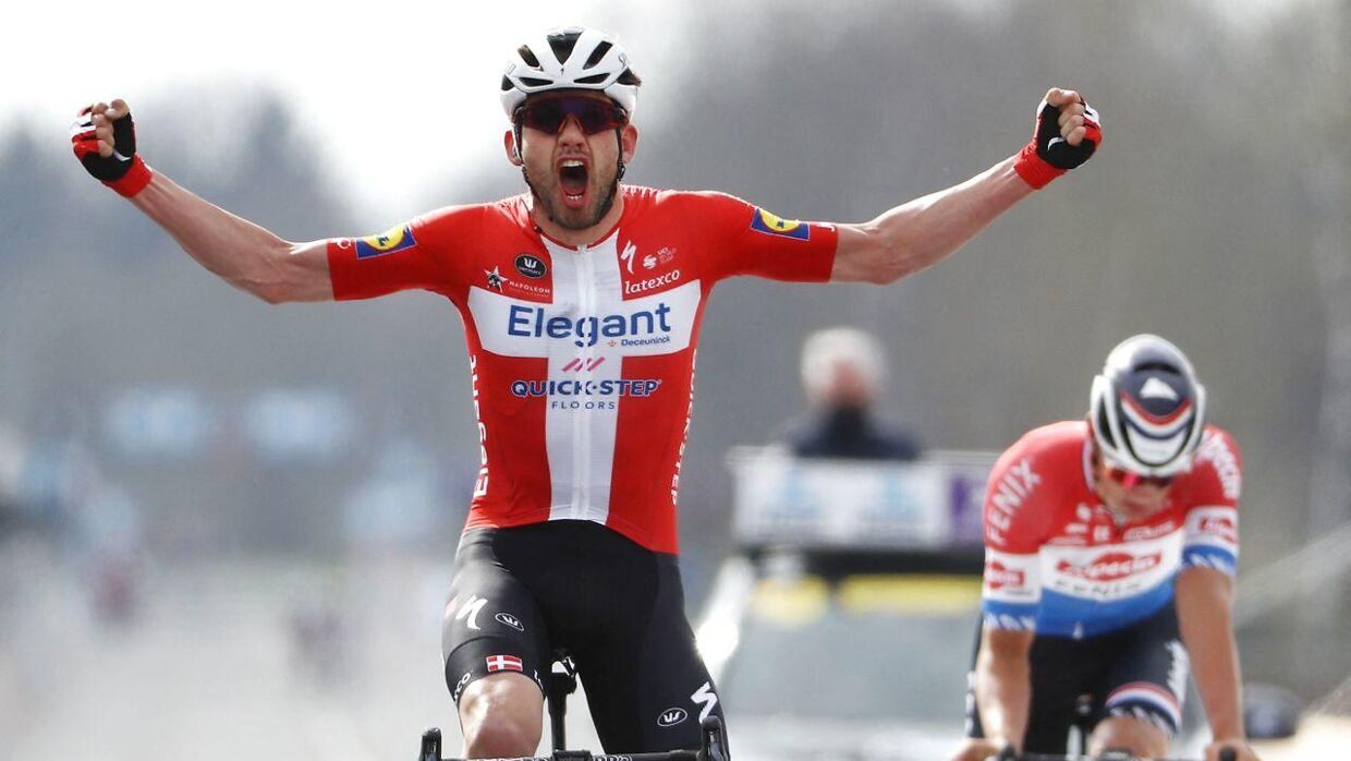 Danish Kasper Asgreen of Deceuninck-Quick-Step celebrates as he crosses the finish line to win the 105th edition of the "Ronde van Vlaanderen, Tour of Flanders" one day cycling race, from Antwerp to Oudenaarde, on April 4, 2021 in Oudenaarde. (Photo by DAVID PINTENS / BELGA / AFP) / Belgium OUT