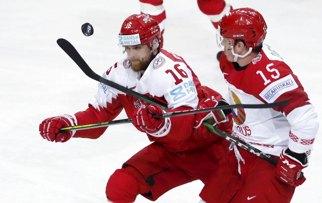 epa09233938 Matthias Asperup (L) of Denmark in action against Artyom Demkov of Belarus during the IIHF 2021 World Ice Hockey Championships group A match between Denmark and Belarus at the Olympic Sports Centre in Riga, Latvia, 28 May 2021. EPA/TOMS KALNINS
