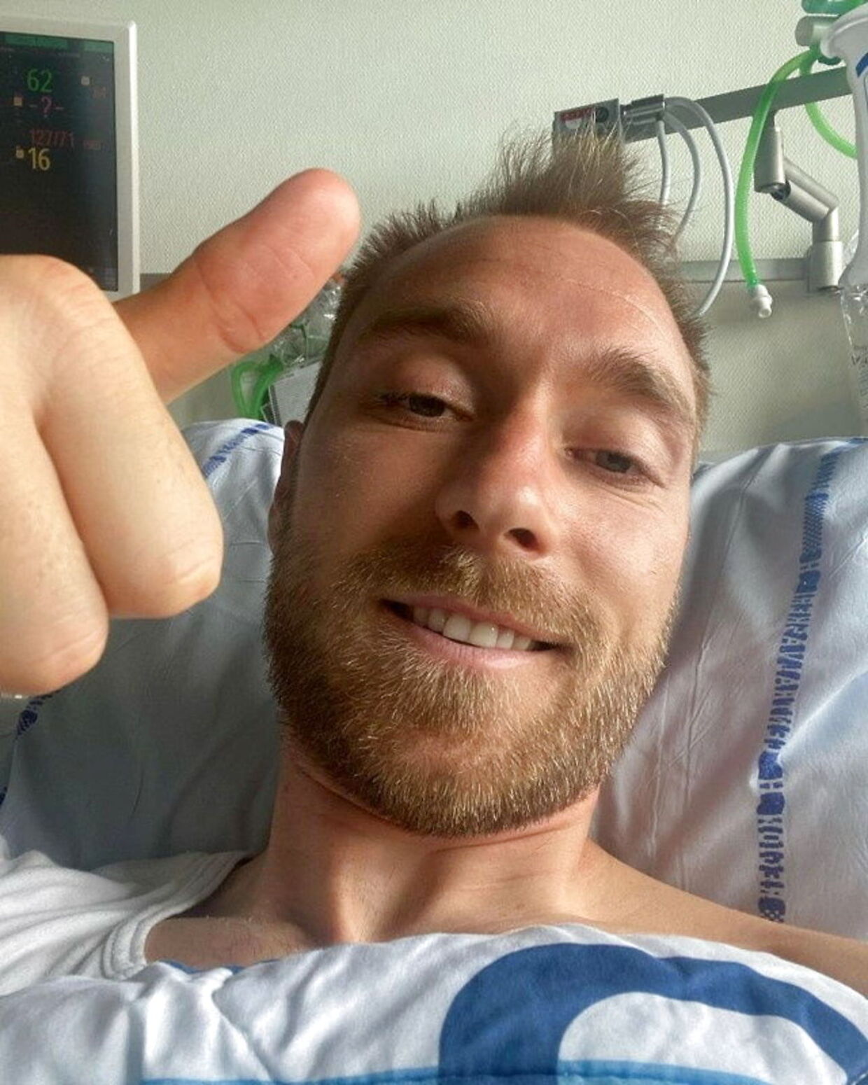 FILE PHOTO: Danish footballer Christian Eriksen gives a thumbs-up at Rigshospitalet, where he is treated after he collapsed during a UEFA Euro 2020 game on Saturday, in Copenhagen, Denmark, in this picture obtained from social media. Picture published June 15, 2021. Danish Football Association/via REUTERS/File Photo
