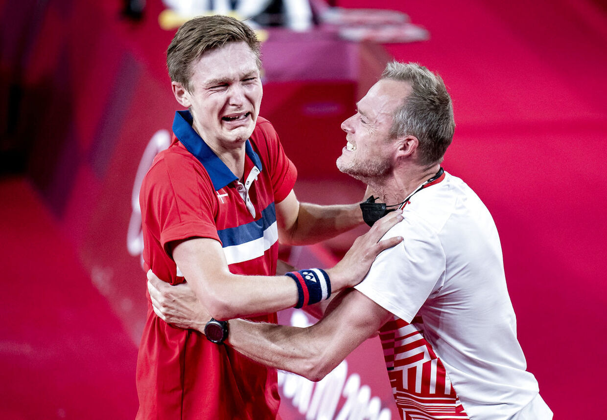 Viktor Axelsen ses her i jubel sammen med landstræner Kenneth Jonassen efter sejren i OL-finalen.