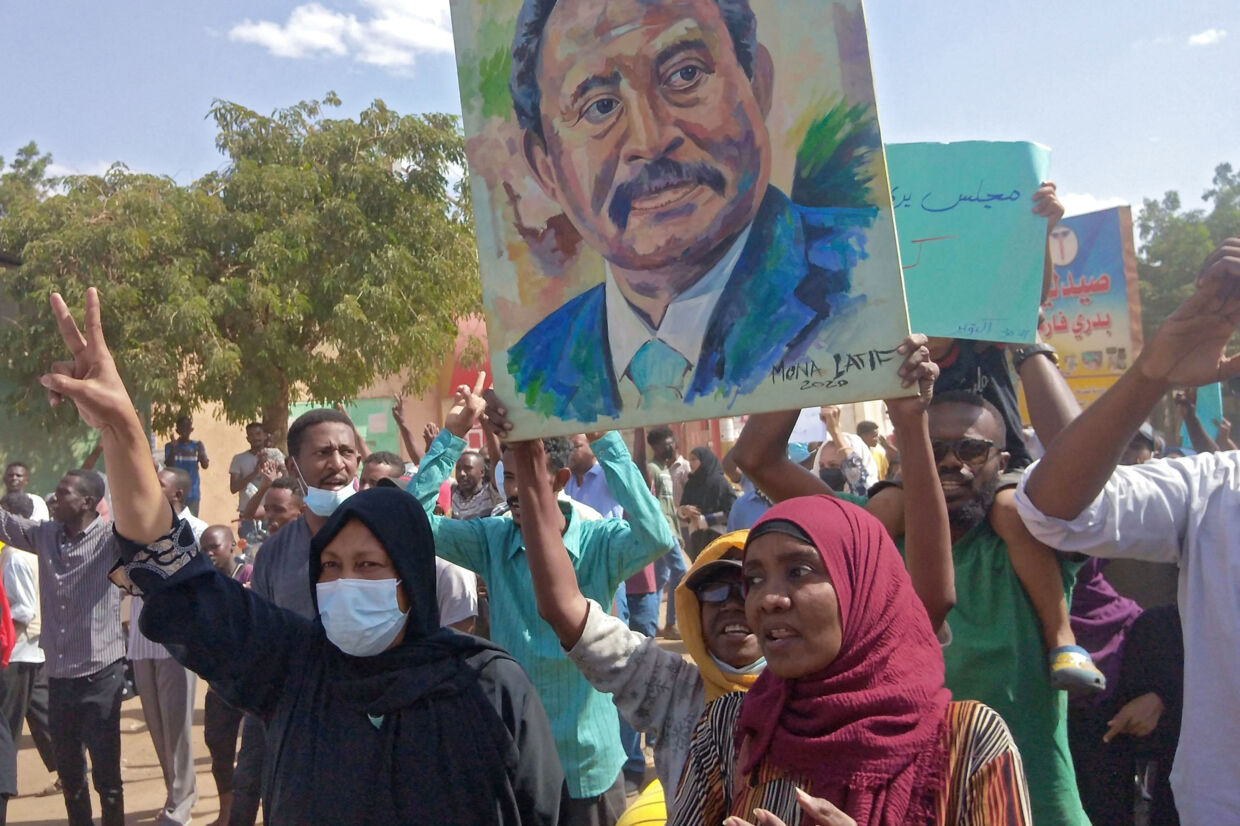 Demonstranter i Sudans hovedstad, Khartoum, lørdag med et portræt af den tilbageholdte civile premierminister, Abdalla Hamdok. -/Ritzau Scanpix