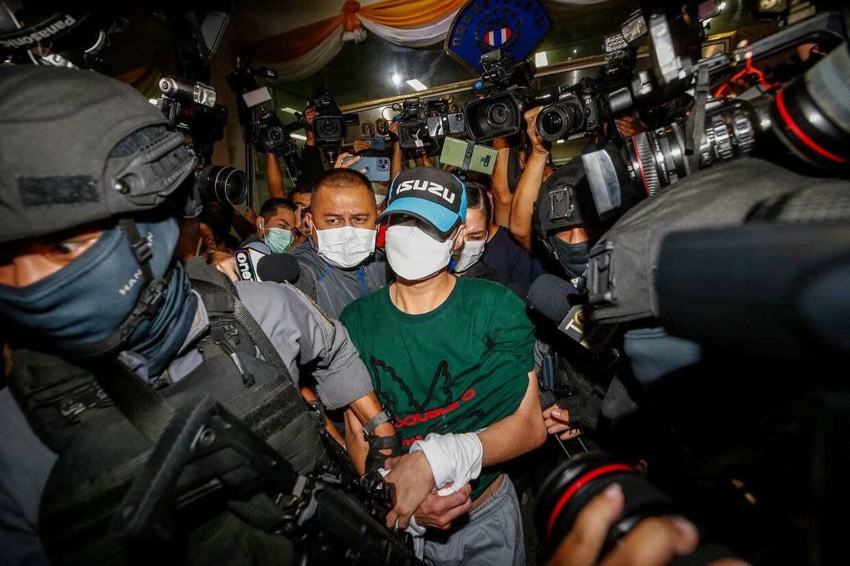 This picture taken on August 26, 2021 shows former Nakhon Sawan province district police station chief Thitisan Utthanaphon, nicknamed "Joe Ferrari", leaving the Crime Suppression Division in Bangkok, after he surrendered to the authorities following accusations of torture and suffocation to death of a drug suspect. - The case of a flashy cop who fell from grace following the leaking of footage of a brutal interrogation has put the spotlight on endemic police corruption in Thailand that infects almost every level of society. (Photo by Krit Phromsakla Na SAKOLNAKORN / THAI NEWS PIX / AFP) / TO GO WITH: Thailand-police-corruption-politics, FOCUS by Pathom Sangwongwanich and Sophie Deviller