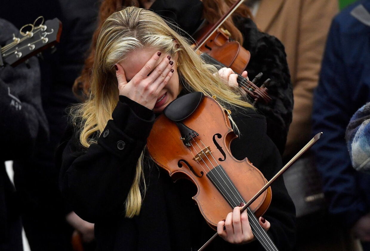 A musician reacts during the funeral of late 23-year-old teacher, Ashling Murphy, who was murdered while out jogging, outside the St. Brigid's Church in Mountbolus near Tullamore, Ireland January 18, 2022. REUTERS/Clodagh Kilcoyne TPX IMAGES OF THE DAY