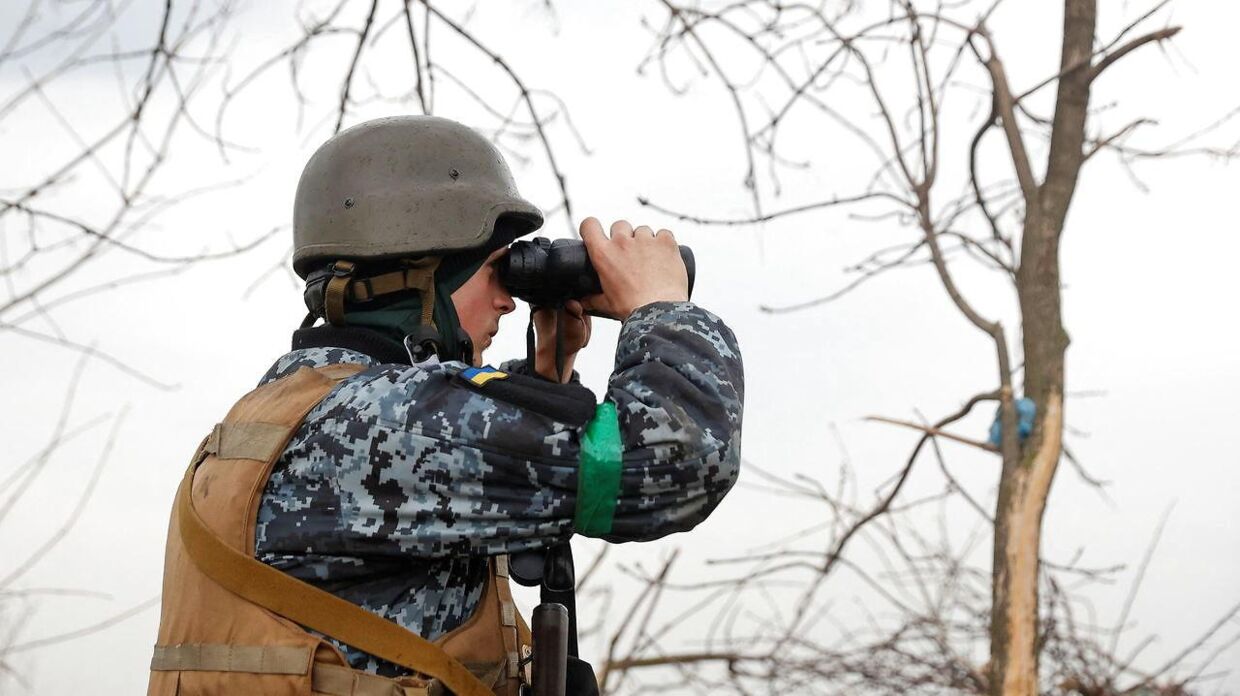 A Ukrainian serviceman looks on with a binocular, as Russia's attack on Ukraine continues, at a position in Donetsk Region, Ukraine April 18, 2022. REUTERS/Serhii Nuzhnenko