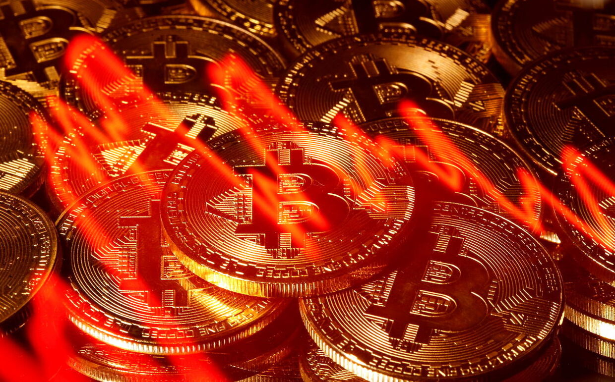 FILE PHOTO: Illumination of the stock graph is seen on the representations of virtual currency Bitcoin in this picture illustration taken taken March 13, 2020. REUTERS/Dado Ruvic/Illustration/File Photo