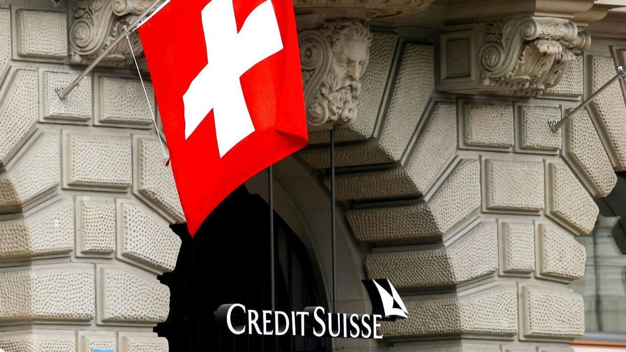 FILE PHOTO: Switzerland's national flag flies above the logo of Swiss bank Credit Suisse at its headquarters in Zurich, Switzerland April 18, 2021. REUTERS/Arnd Wiegmann/File Photo
