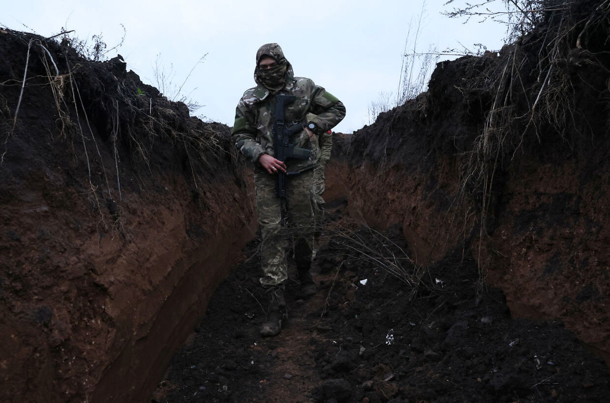En ukrainsk soldat i en primitiv skyttegrav.