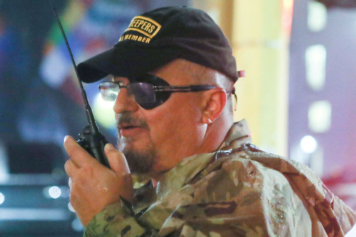 FILE PHOTO: Oath Keepers militia founder Stewart Rhodes uses a radio as he departs with volunteers from a rally held by U.S. President Donald Trump in Minneapolis, Minnesota, U.S. October 10, 2019. Picture taken October 10, 2019. REUTERS/Jim Urquhart/File Photo