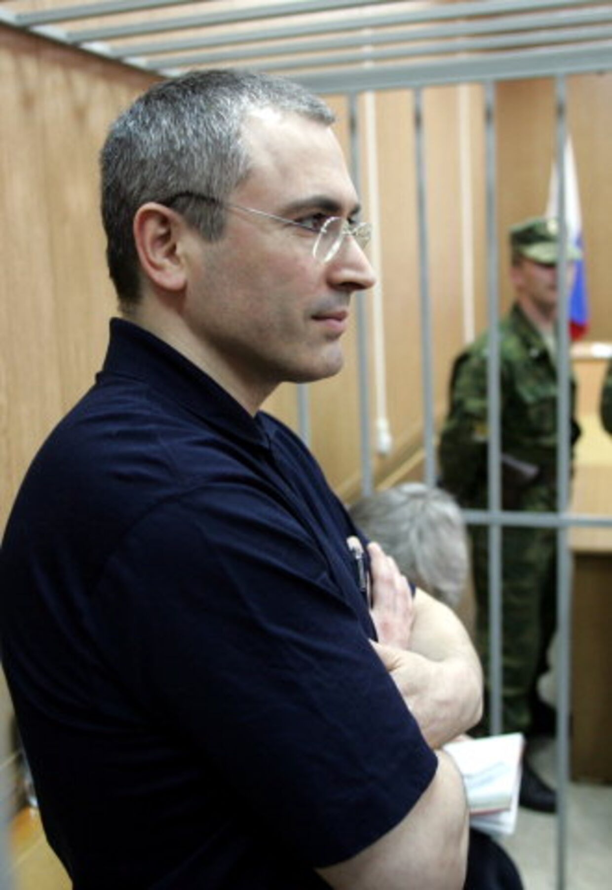 Den russiske oliemilliardær Mikhail Khodorkovskij står i sin lille celle i retssalen i Moskva mandag. Foto: Alexander Natruskin/Reuters